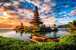 Pura Ulun Danu Bratan, Hindu temple with boat on Bratan lake landscape at sunrise in Bali, Indonesia.